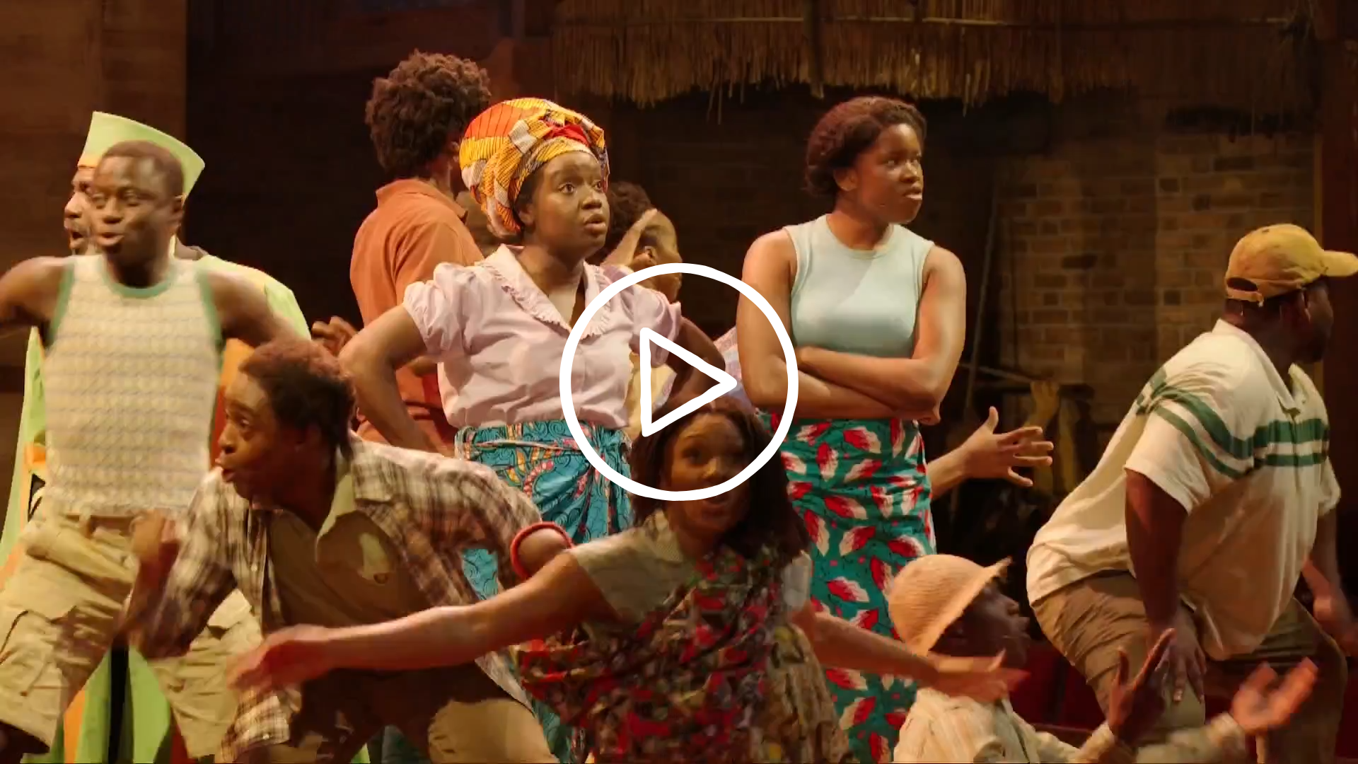 Cast of The Boy Who Harnessed the Wind in colourful costume singing and dancing